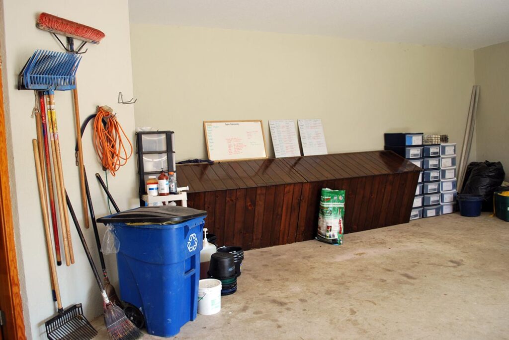 a clean and tidy horse feed room with feed storage and supplies