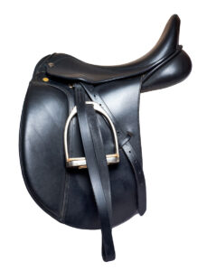 a black leather dressage english saddle on a white background