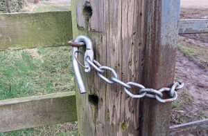 A close-up of a Kiwi style gate latch on a horse's pasture gate