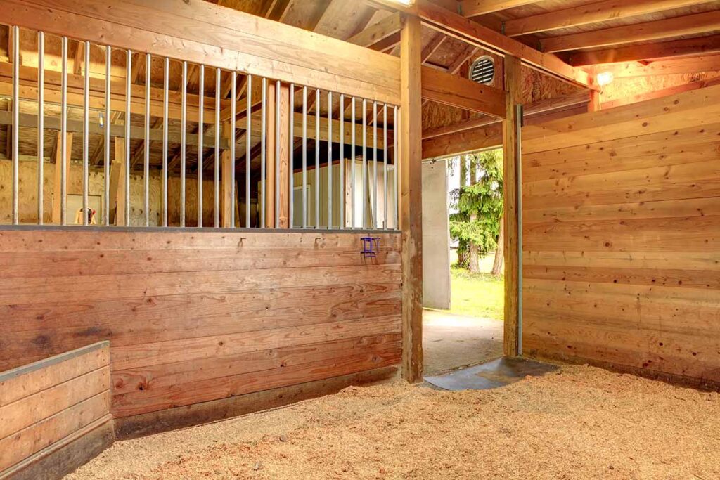 A clean horse stall with fresh bedding